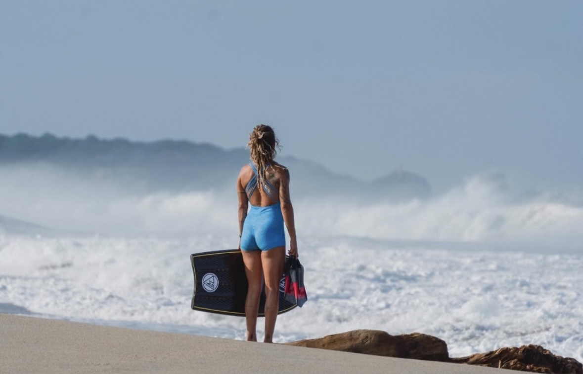 Chia with bodyboard looking at waves